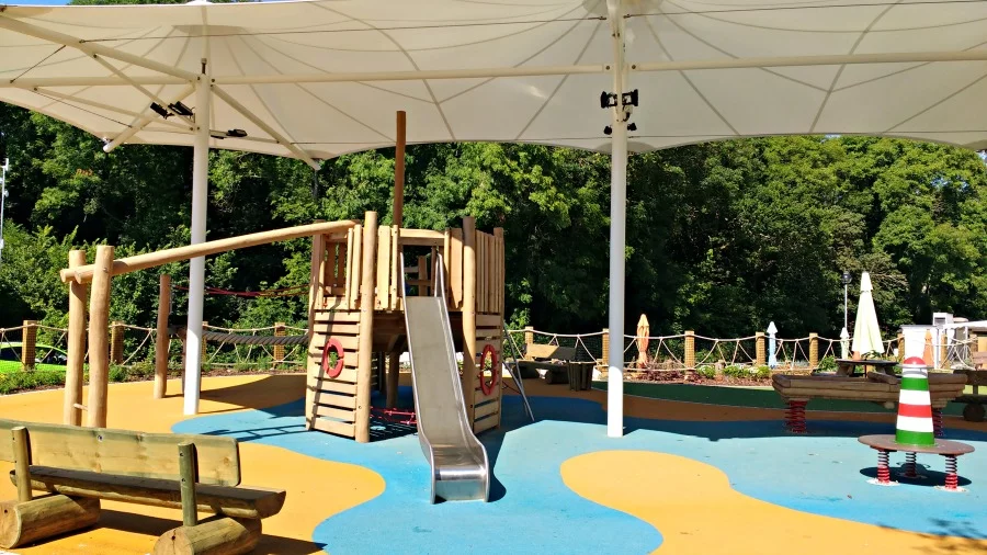 Shaded outdoor playground at Whitecliff Bay